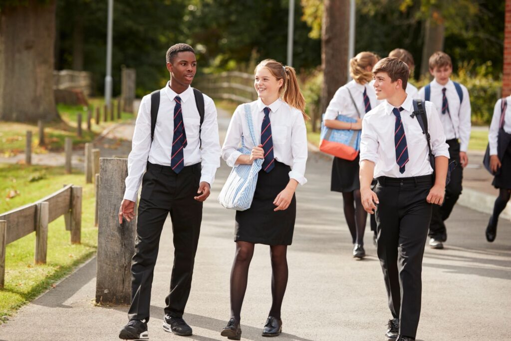 A group of teenagers walking in school uniform