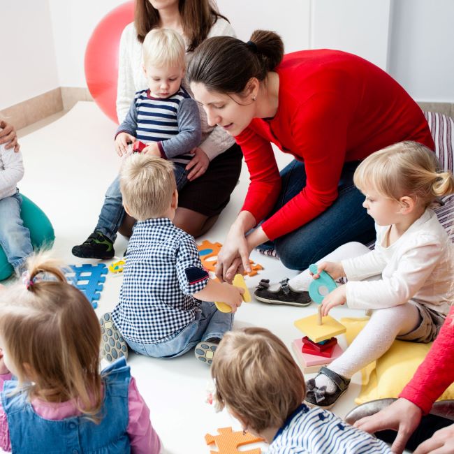 Mums at a playgroup with toddlers and ore-school children