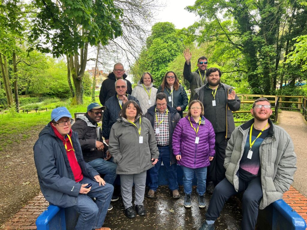 A group of people at Wiltshire Community Outreach Service smiling outdoors