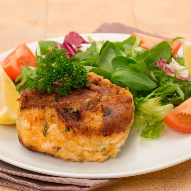 A plate of fishcakes with salad